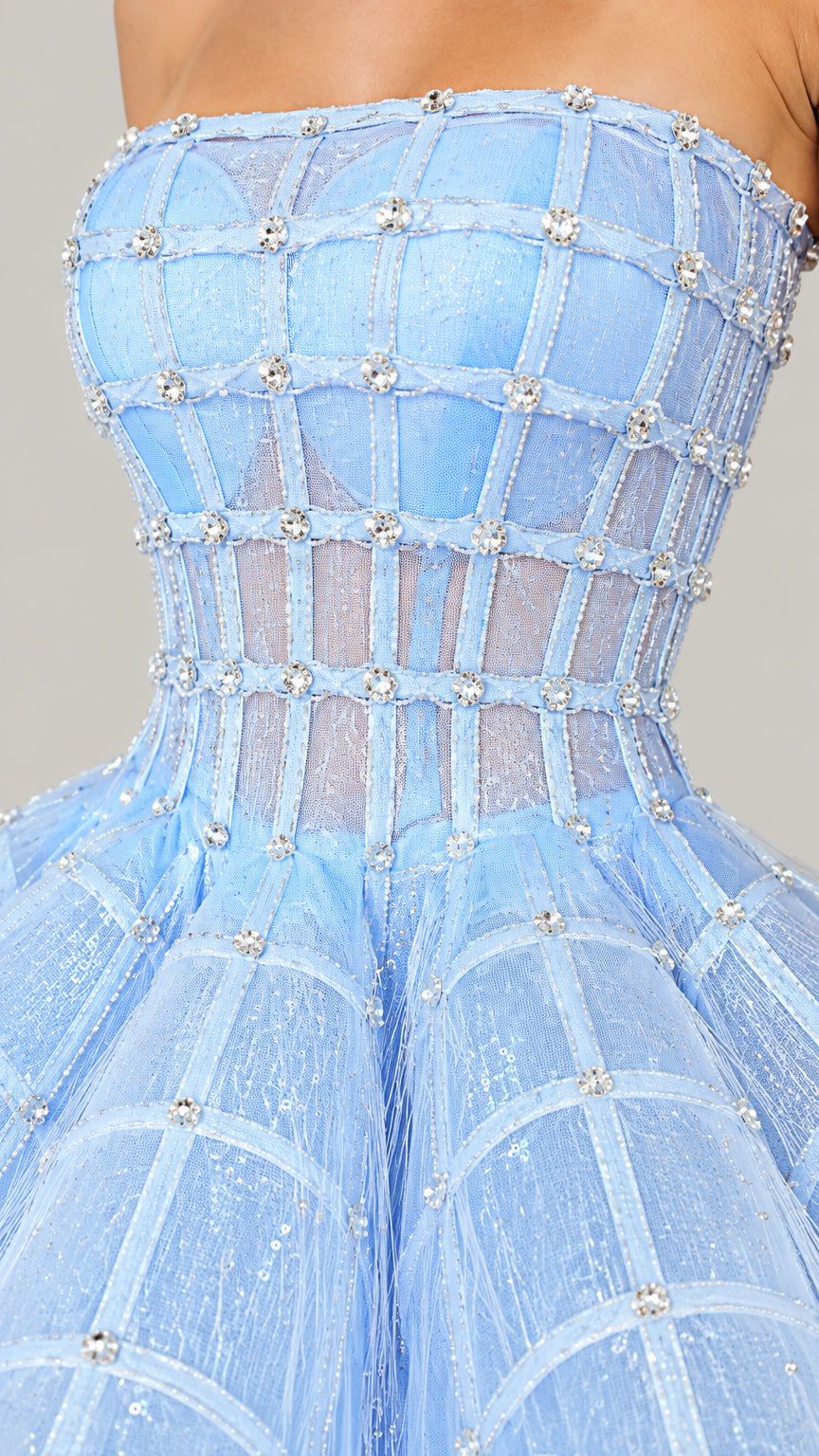 Close-up detail of light blue corset bodice featuring grid beading and crystal embellishments