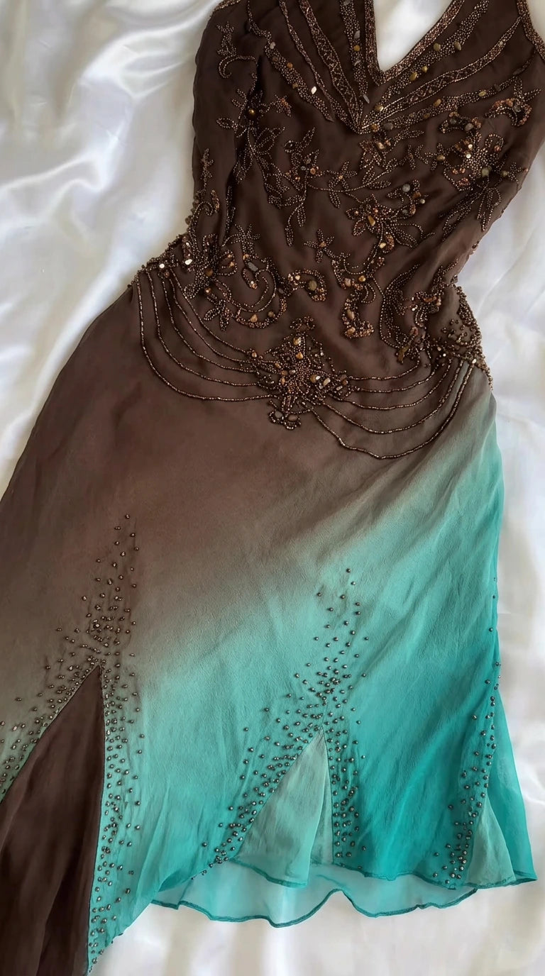 Close-up detail of beaded bodice and turquoise godet hem fabric