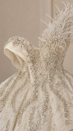 Close-up of champagne beaded bodice and sculpted feather shoulder detail