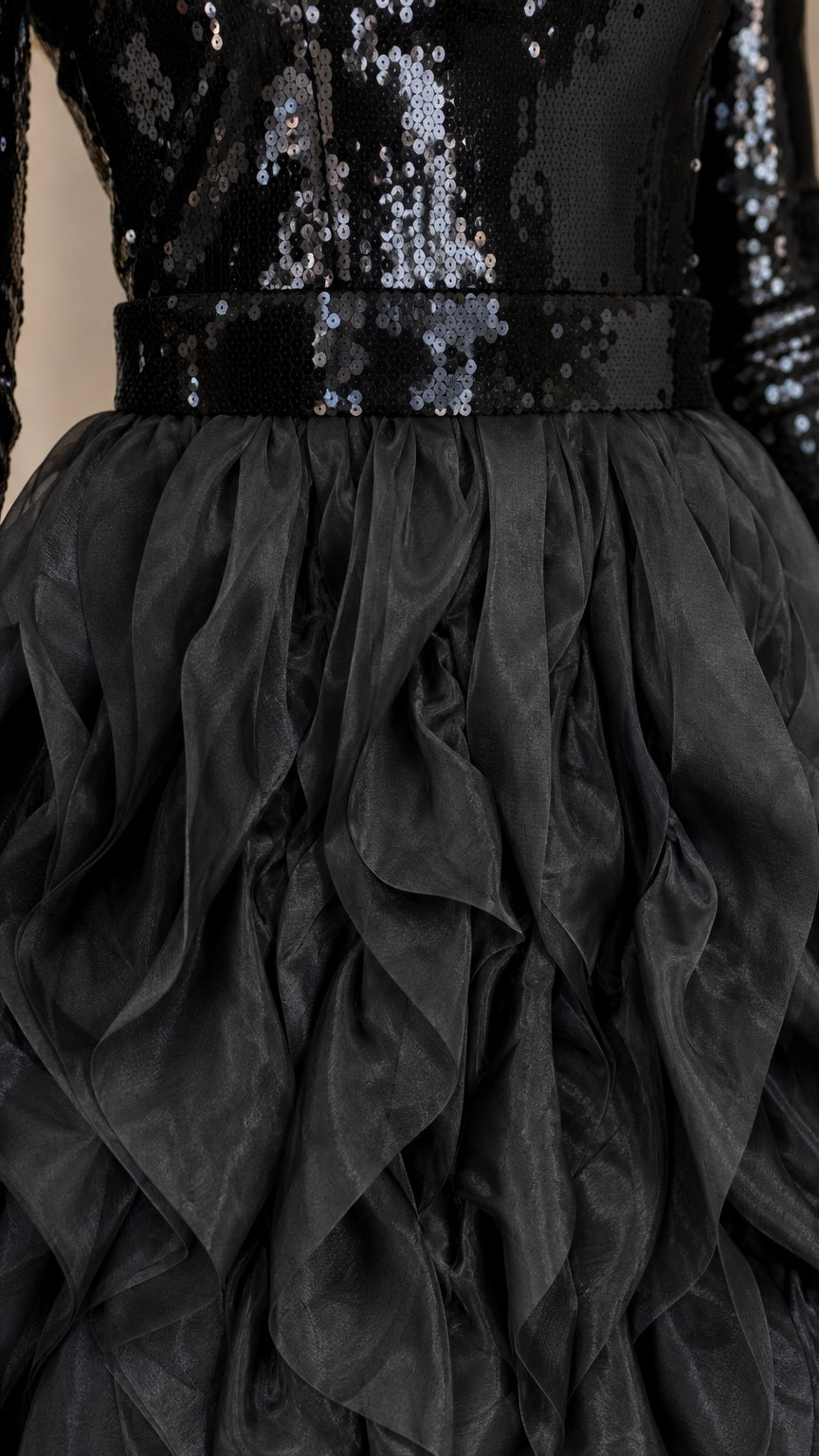 Close-up detail of black sequin bodice and textured ruffle fabric waistband