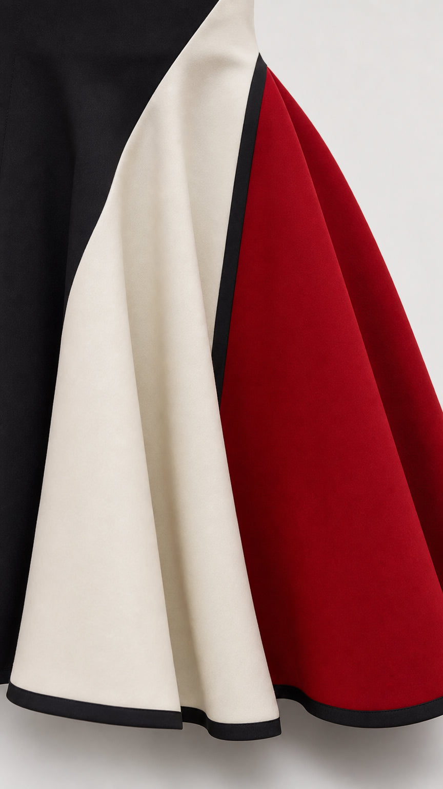 Close-up detail of the tri-color panel construction and contrast piped hem