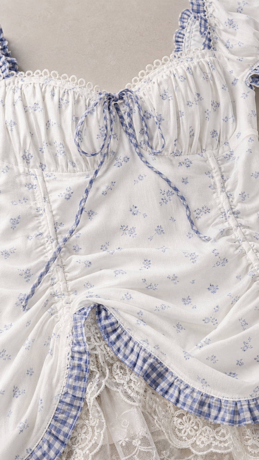 Close-up detail of sweetheart neckline, front tie bow, and lace gingham hem trim