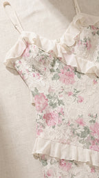 Close-up detail of floral lace texture, neckline ruffle trim, and adjustable straps