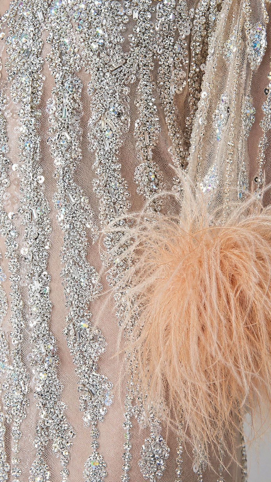 Close-up detail of intricate crystal beadwork and feather cuff trim