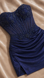 Flat lay close-up view showing the beaded lace and boning detail of the Navy Blue corset dress