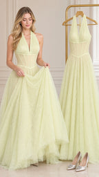 Model holding skirt of light yellow lace evening gown next to dress on rack