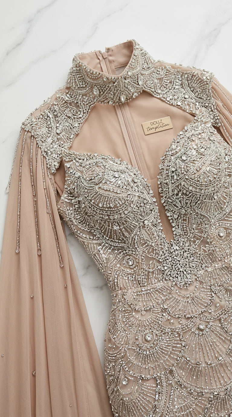 Close-up flat lay of detailed crystal and bead embroidery on high-neck bodice and cape shoulder