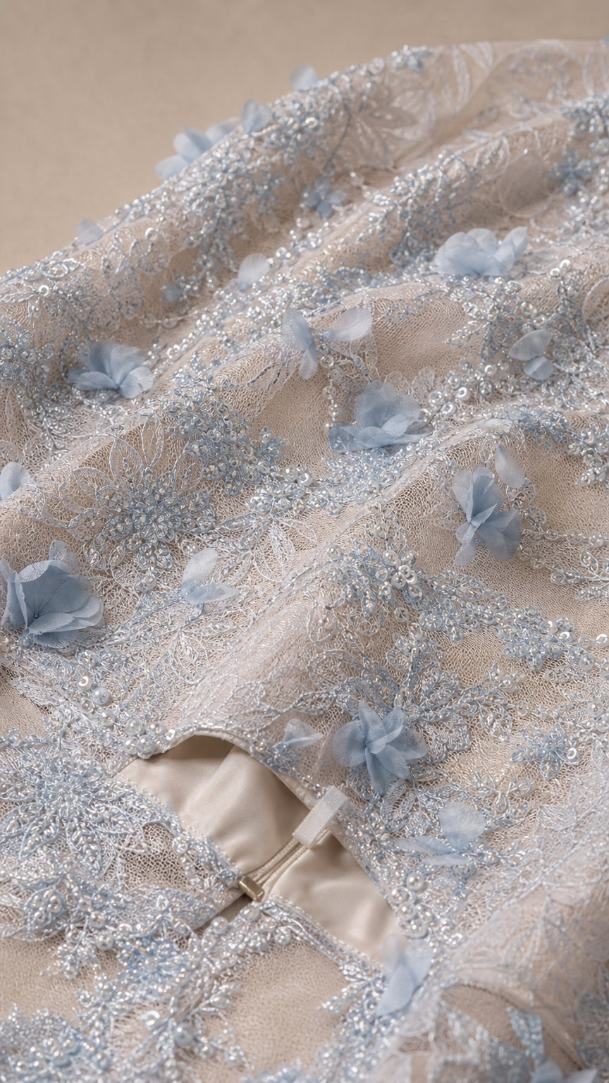 Close-up detail of 3D floral appliques, embroidery, and back zipper