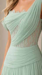 Close-up detail of sage green ruched tulle and floral lace bodice construction
