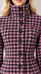 Close-up detail of high stand collar and front buttons on pink and black plaid jacket