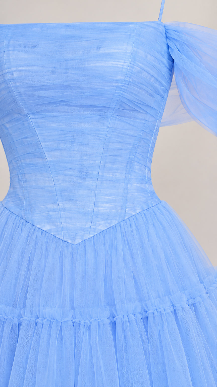 Close-up of light blue ruched bodice and draped tulle shoulder sleeve