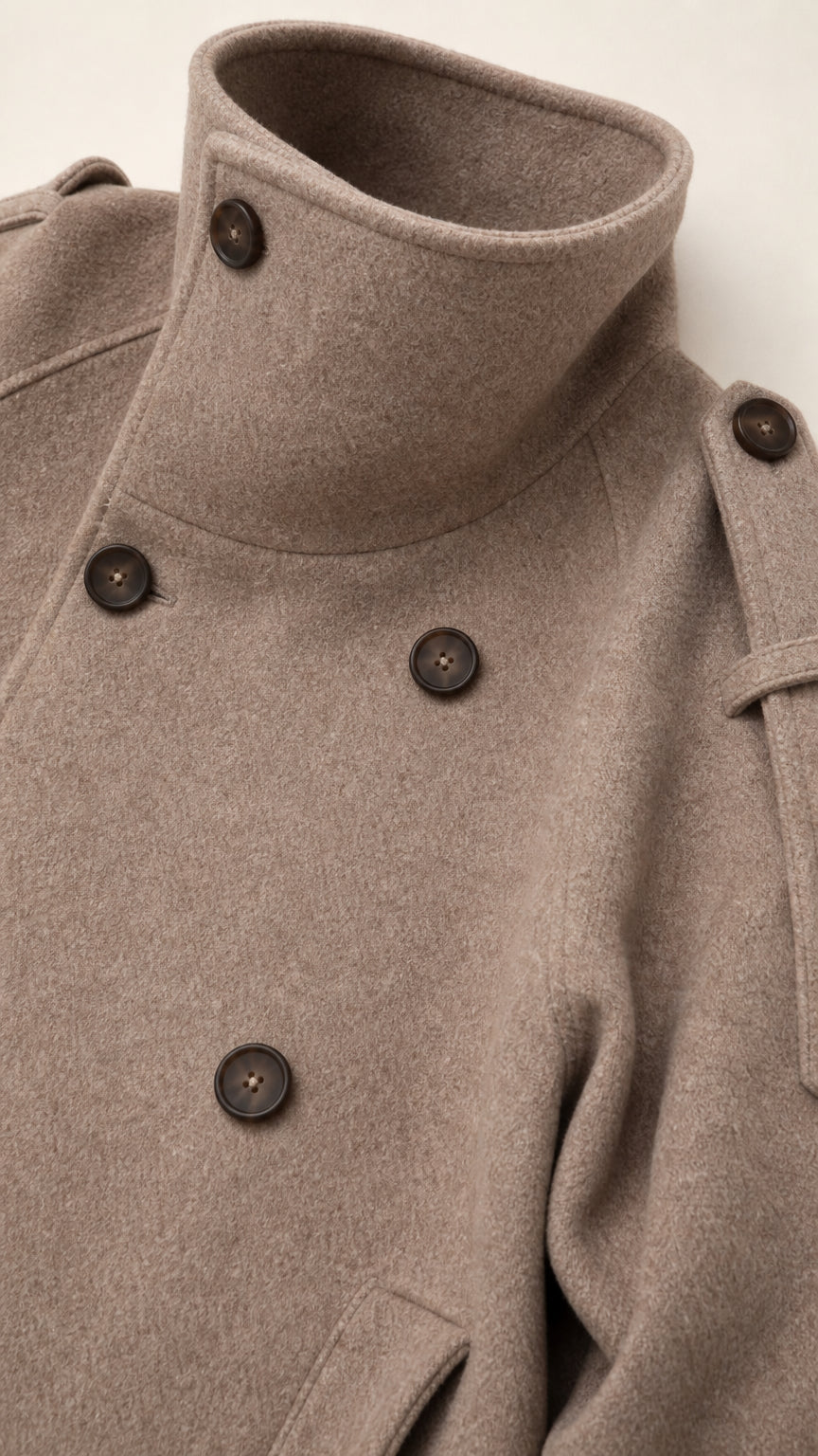 Close-up detail of high buttoned funnel collar and wool fabric texture in taupe
