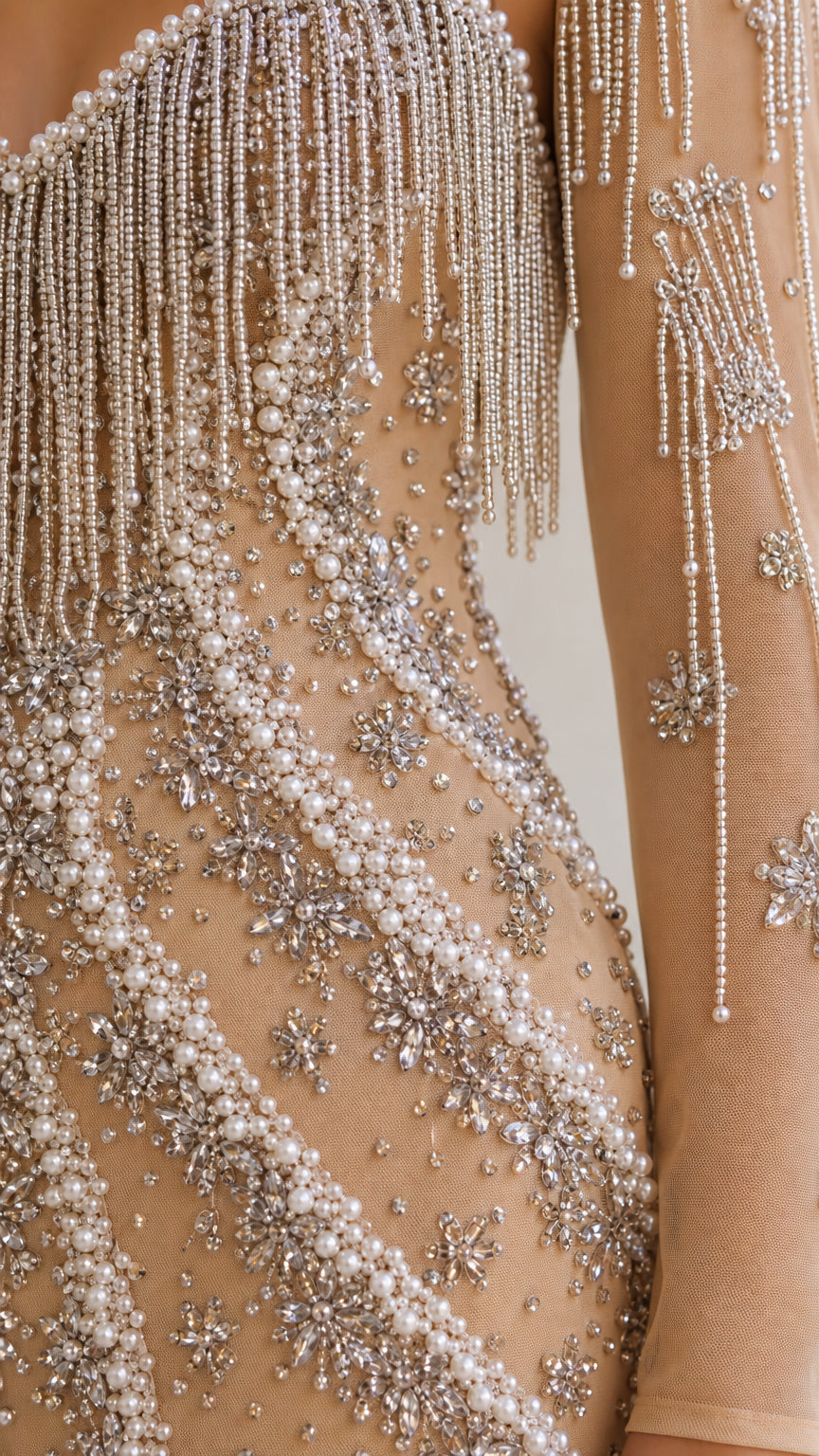 Close-up detail of pearl embellishments and beaded fringe trim