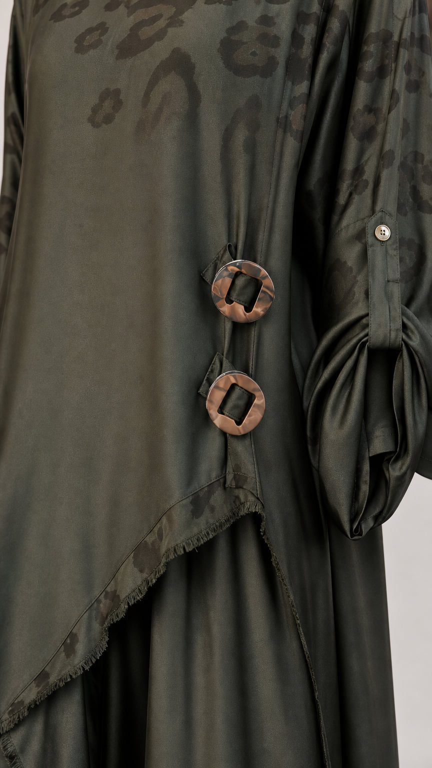 Close-up detail of olive green tunic decorative ring buckles and jacquard trim