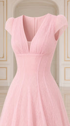 Close-up detail of V-neckline, sheer cap sleeves, and lace bodice on pink gown