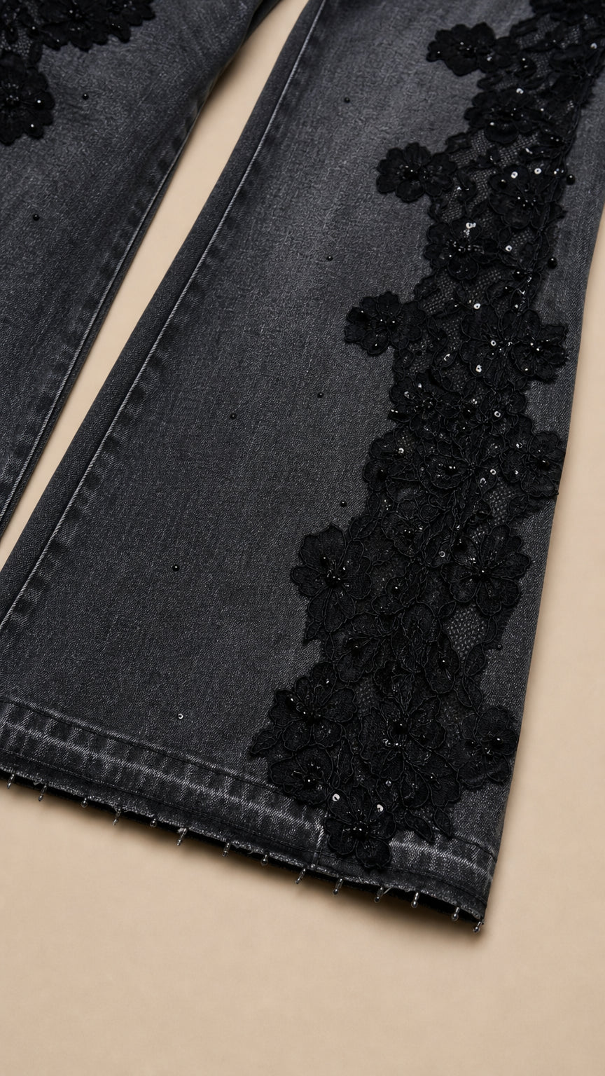 Close up detail of floral lace embroidery and subtle sequin embellishment on denim hem