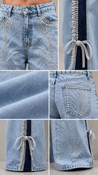Close-up detail shot of denim fabric, rhinestone patterns, and crystal bow hem accents