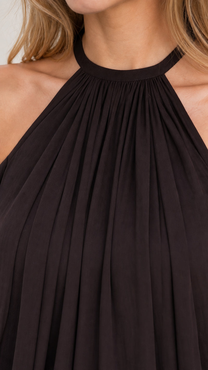 Close-up detail of gathered halter neckline on black chiffon romper