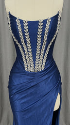 Mannequin close-up showing crystal leaf detailing on royal blue corset bodice
