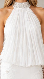 Close-up detail of beaded halter collar and pleated bodice on white dress
