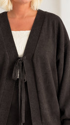 Close-up of charcoal cardigan showing front tie closure and soft knit texture