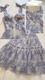 Close-up flat lay of blue floral bodice, molded sweetheart cups, tie straps, and lace-up back