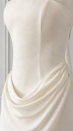Close up of ivory draped cowl waist and structured bodice seams