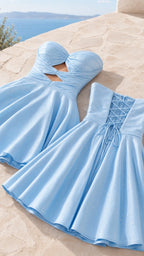 Flat lay of light blue strapless party dress showing front cutout and back lace-up details