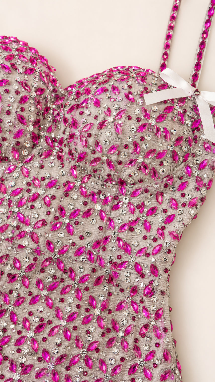 Close-up detail of sweetheart neckline, crystal embellishments, and white bow strap