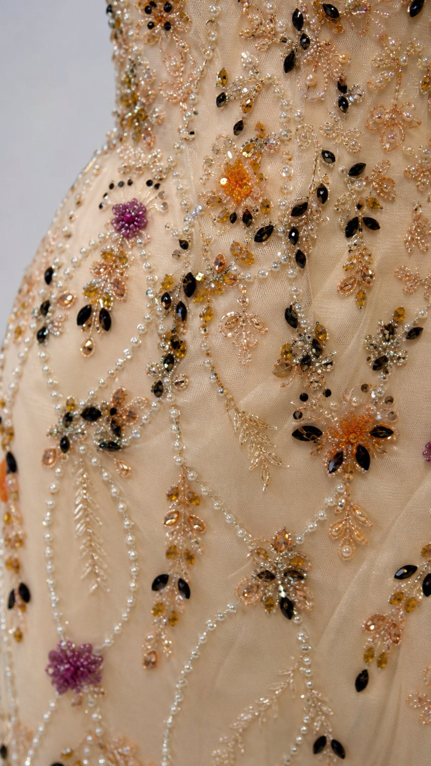 Close up view of intricate floral beadwork and sequin embellishments