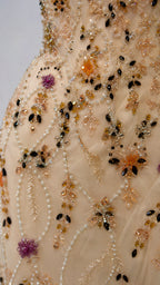 Close up view of intricate floral beadwork and sequin embellishments