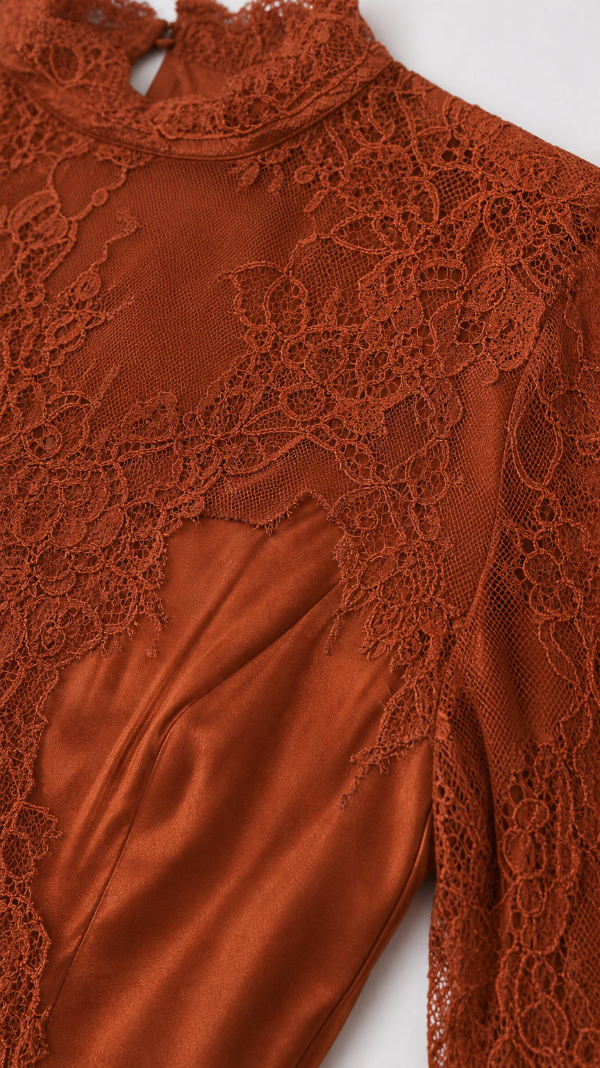 Close-up detail of sheer floral lace high neck and satin shoulder seam in Terracotta