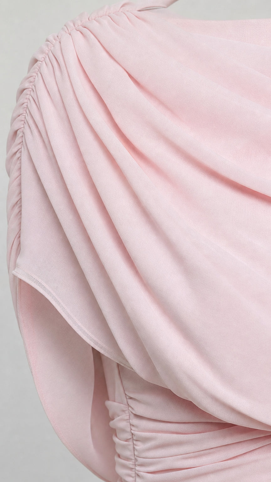 Close-up detail of blush pink soft gathered chiffon fabric on shoulder drape
