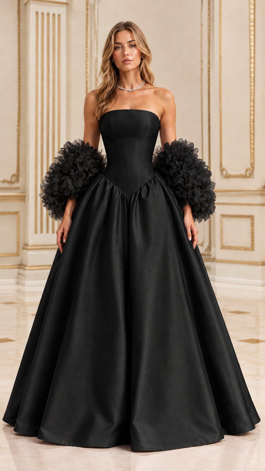 Front view of black strapless basque waist ball gown with voluminous ruffle cuffs