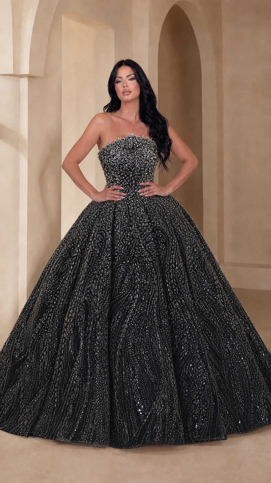 Model wearing black strapless glitter ball gown with beaded sweetheart bodice