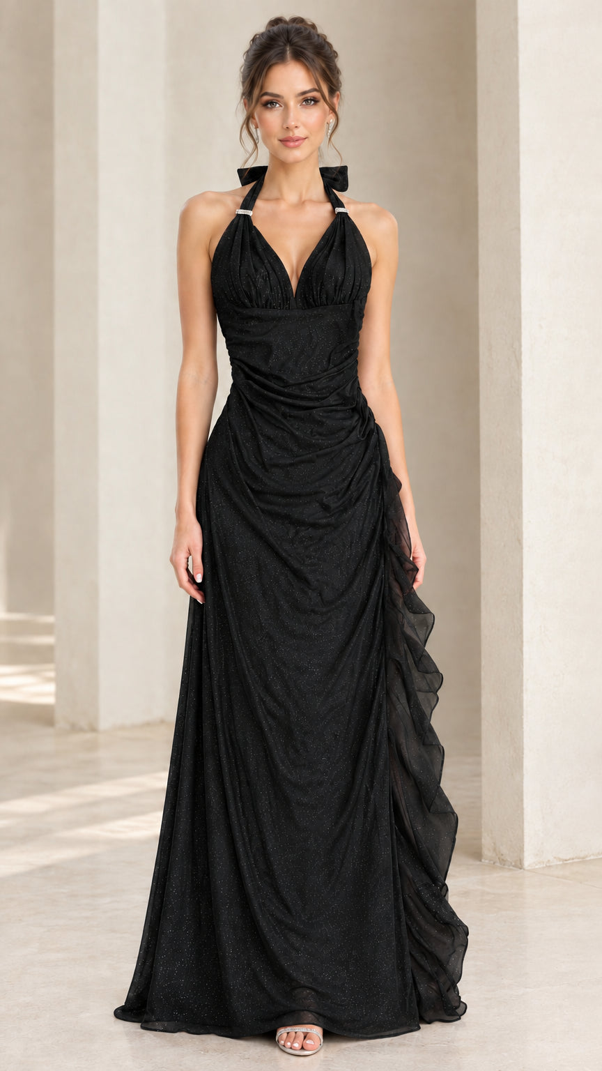 Front view of model wearing black halter ruched evening dress with side ruffle