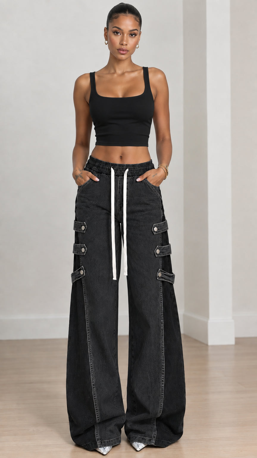 Full front view of washed black two-tone wide-leg denim jeans styled with black crop top