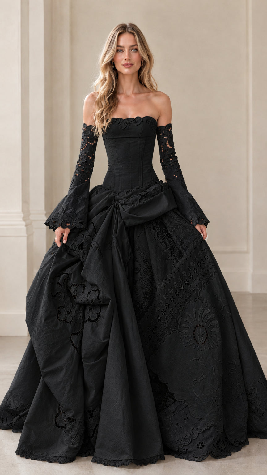 Front view of black corset ball gown with floral lace sleeves and draped skirt