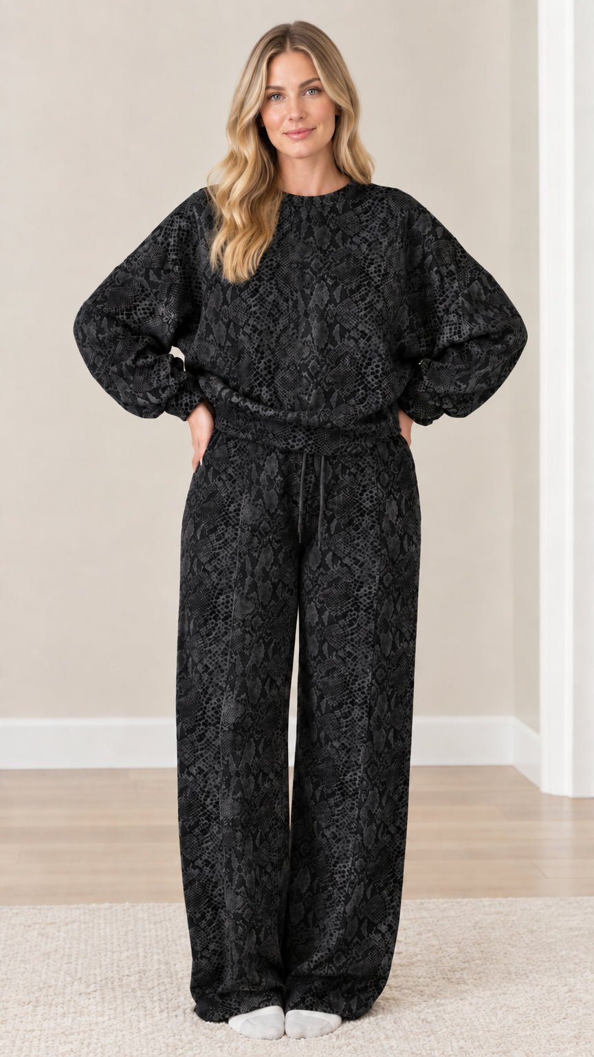Front view of model wearing black and charcoal snakeskin print matching loungewear set