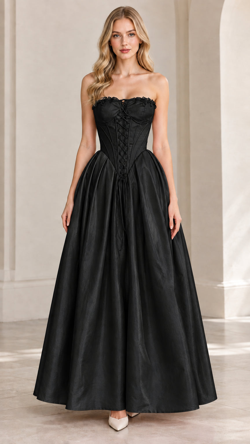 Front view of model wearing black strapless corset evening ball gown