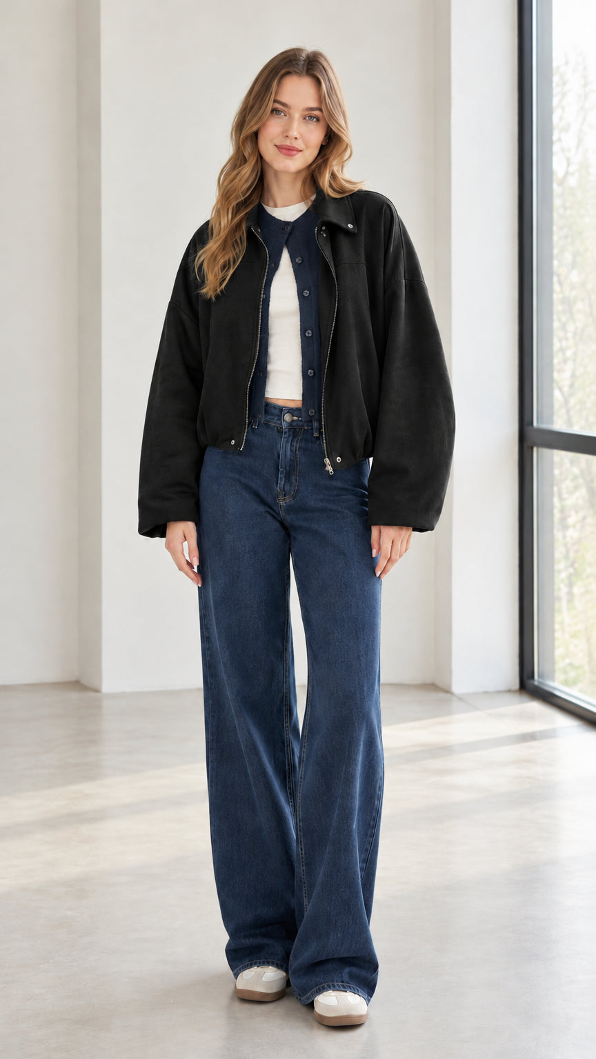 Woman wearing black collared zip-up jacket with denim pants