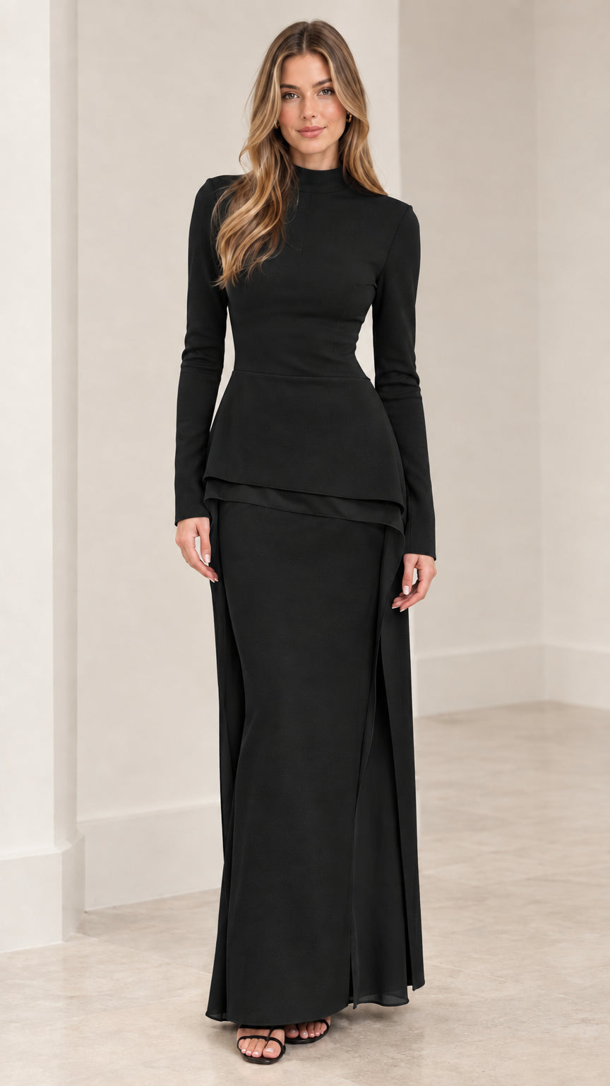 Front view of woman wearing black long sleeve mock neck peplum top and maxi skirt set