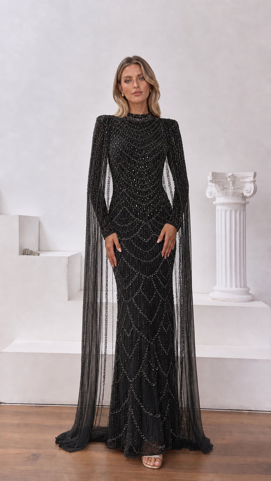 Black high-neck beaded evening gown with sheer flowing cape sleeves