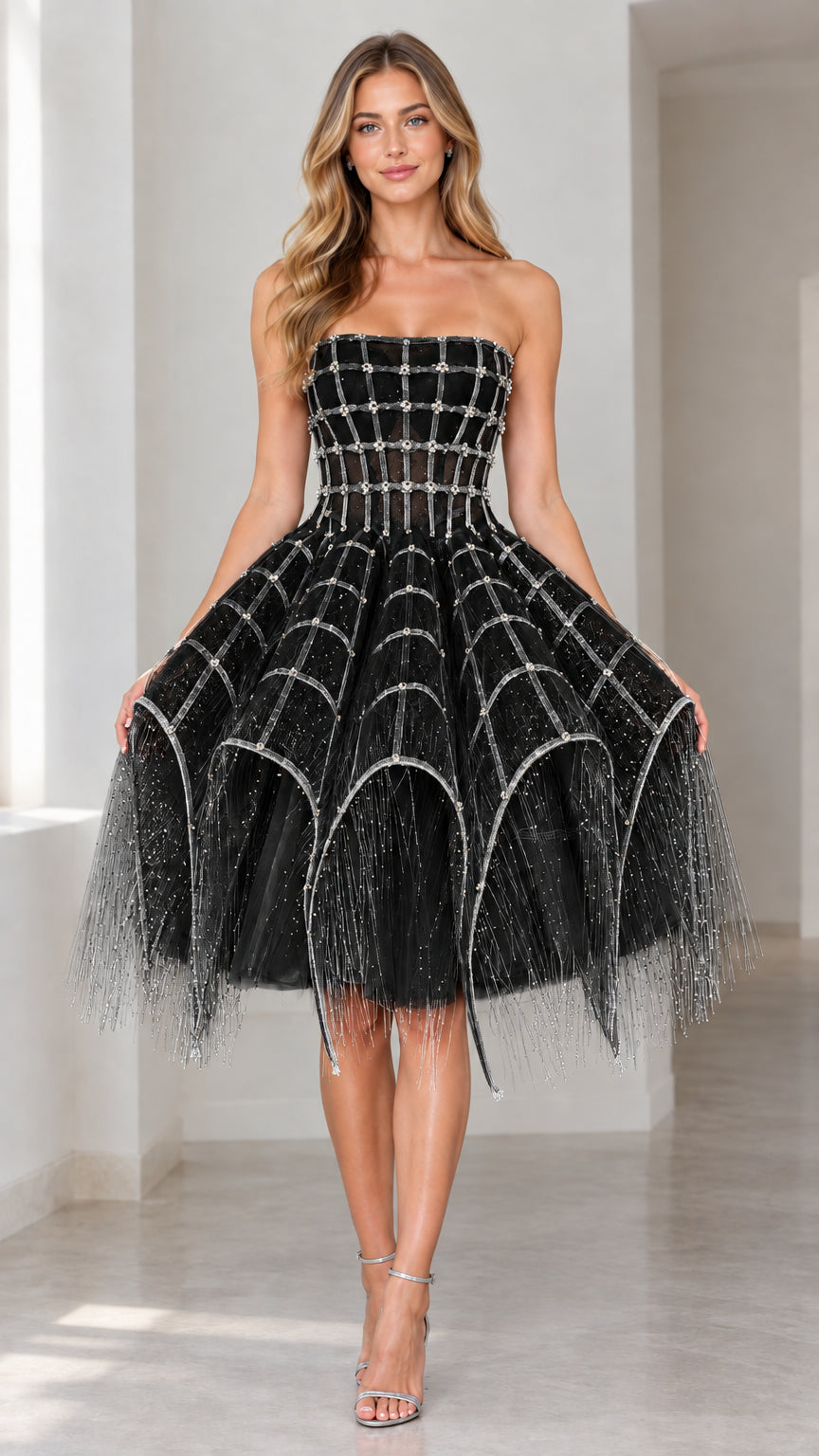 Front view of black strapless embellished corset cocktail dress with tiered fringed skirt