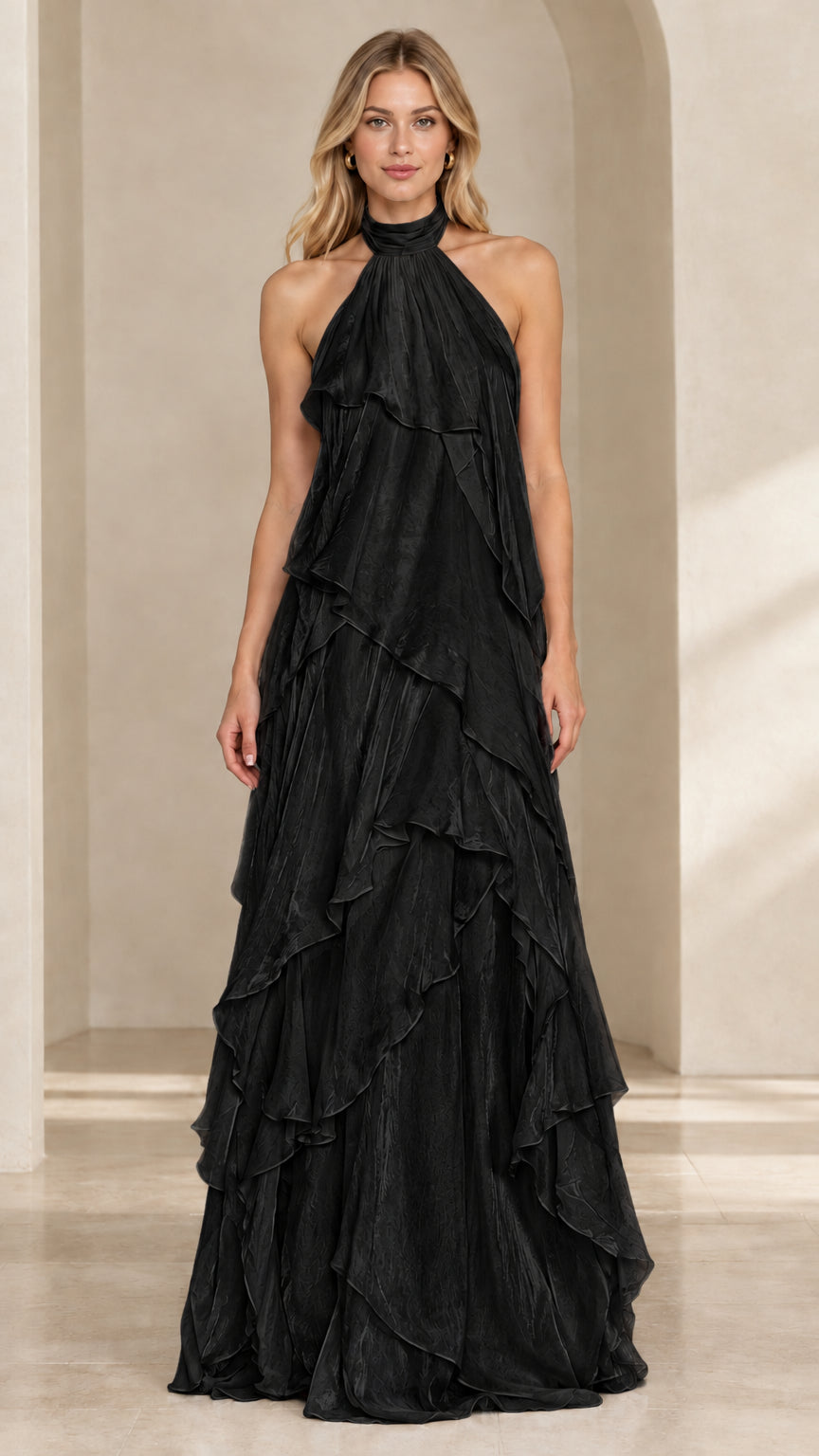 Front view of woman wearing a black halter neck tiered ruffle evening maxi dress