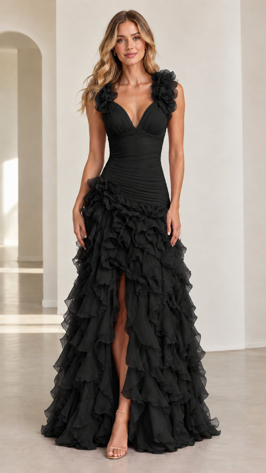 Front view of model wearing black floral applique tiered ruffle maxi gown