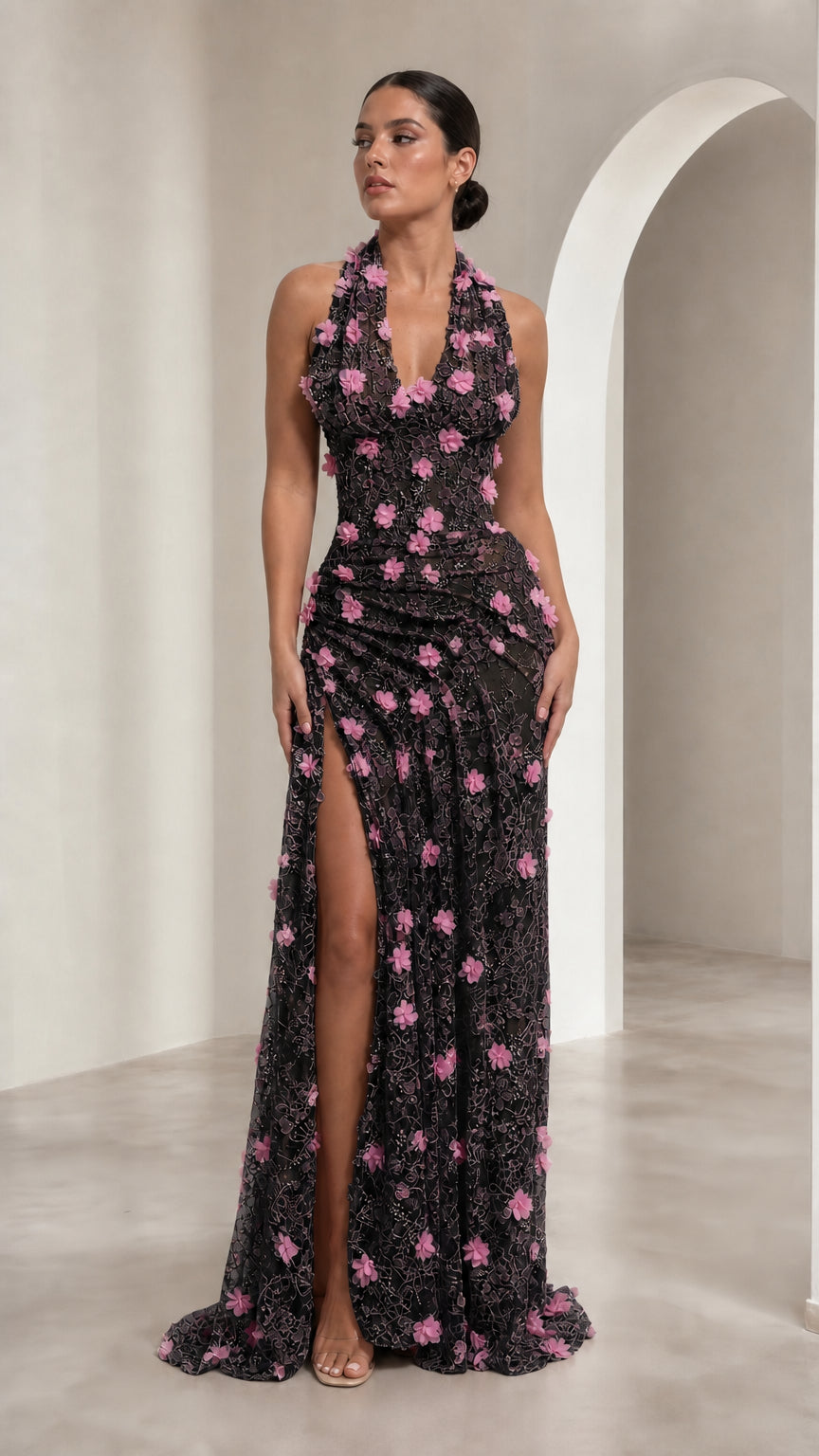 Model wearing Black halter maxi gown with pink 3D floral embellishments