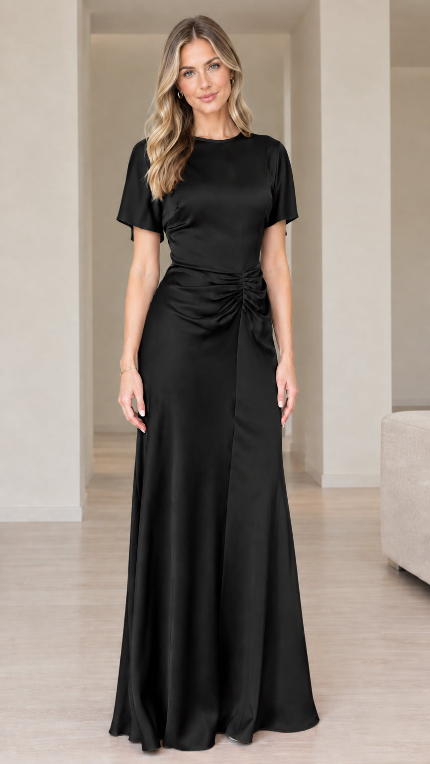 Front view of woman wearing black short sleeve ruched satin maxi dress