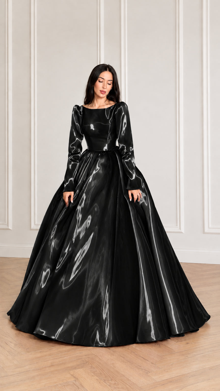 Front view of model wearing black glossy long sleeve satin ball gown