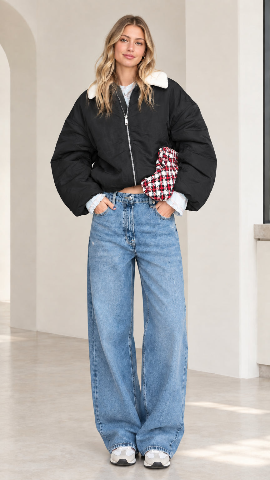 Full-length front view of model wearing black cropped puffer jacket with white fleece collar